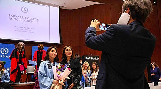 A graduating senior poses for a photo after being celebrated at the Honors Assembly event.