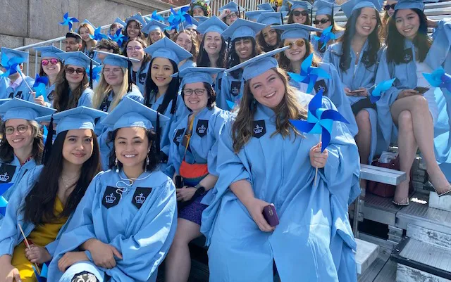 Climate school graduating students wave their pinwheels while waiting for the university-wide Commencement ceremony.