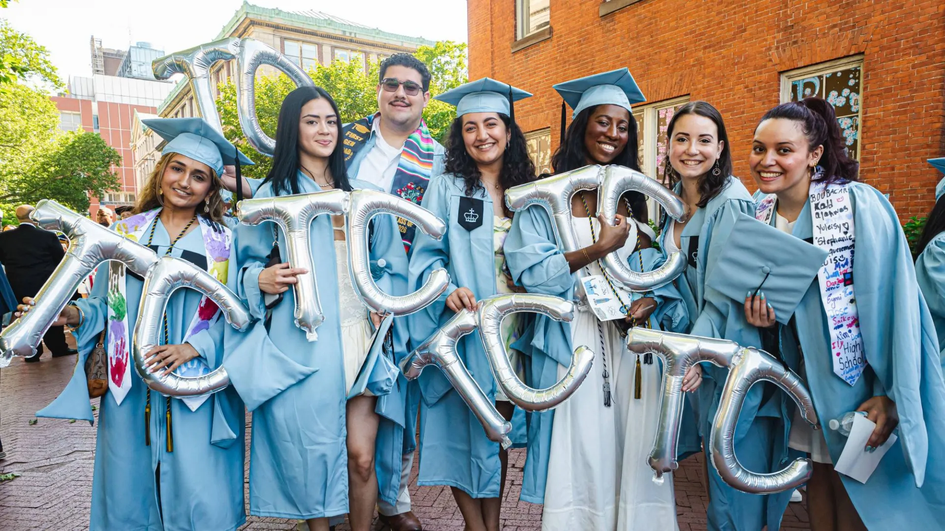 Teachers College graduates with balloons on Commencement by Brandon Vallejo. 