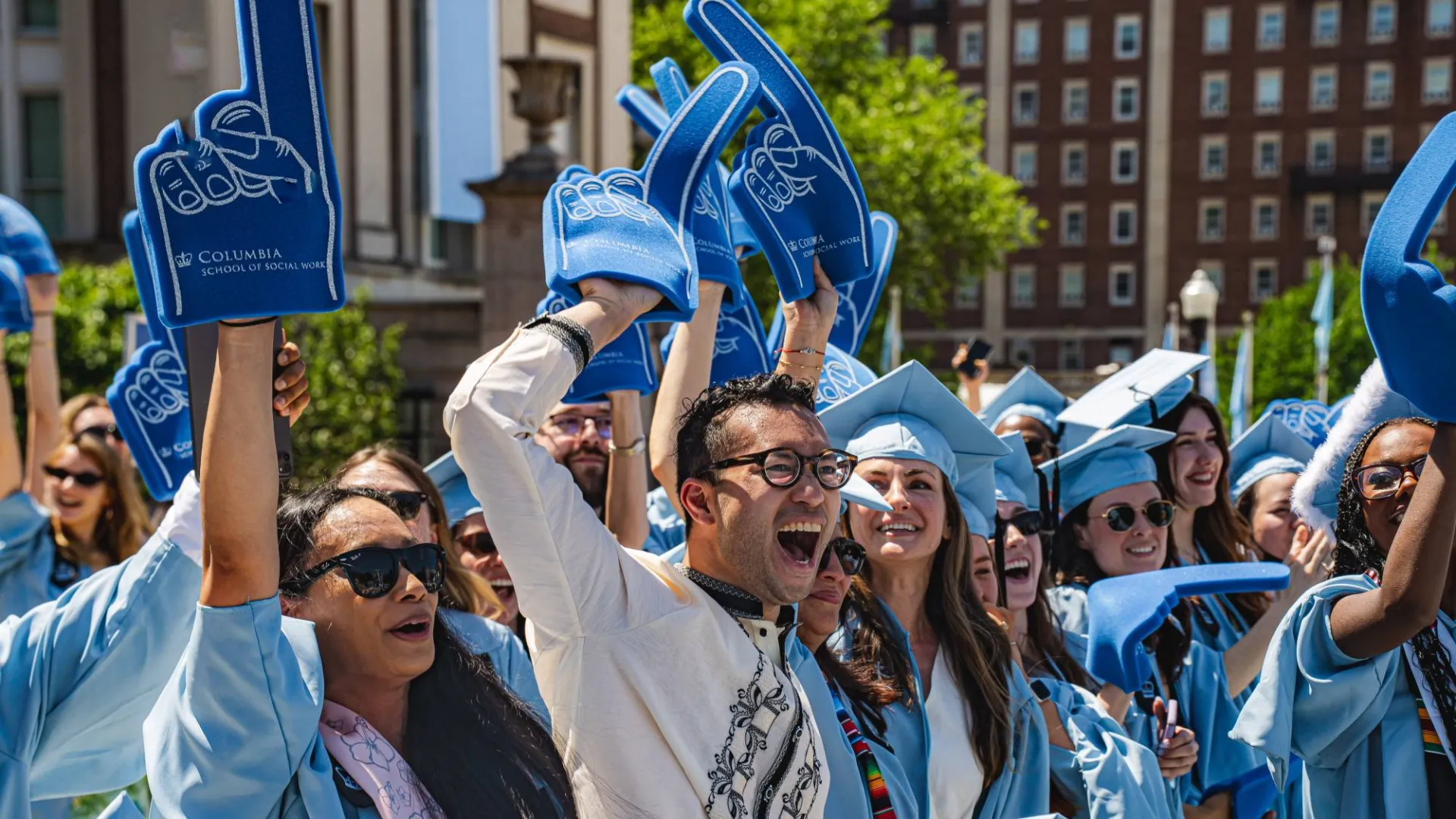 School of Social Work graduates with foam fingers by Brandon Vallejo.
