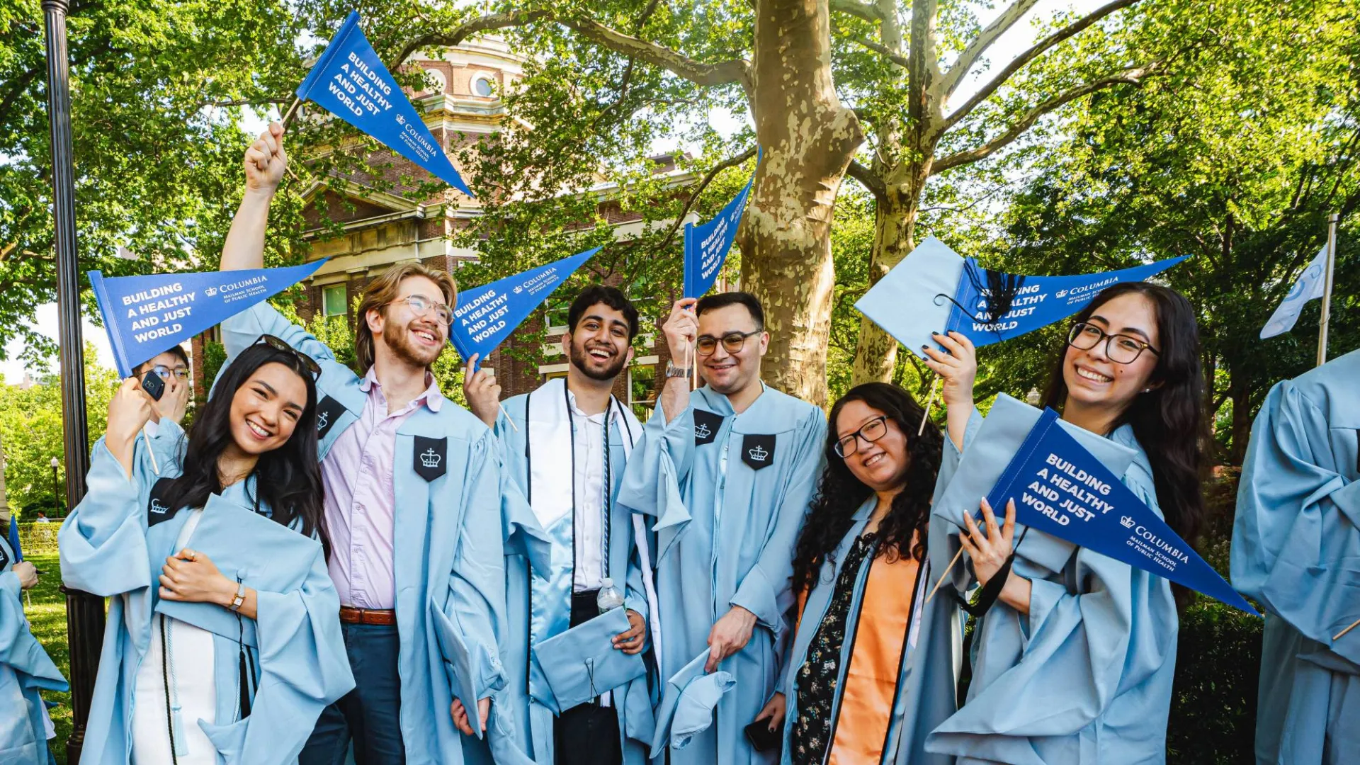 Mailman School of Public Health graduates smiling by Brandon Vallejo.