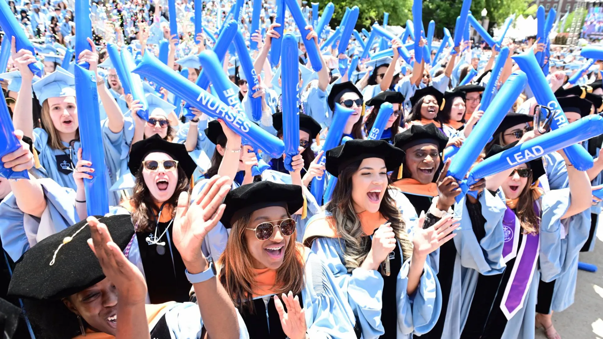 Nursing graduates cheering at Commencement by Chris Taggart.