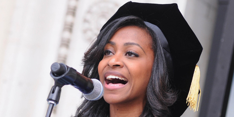 A 2014 graduating student singing at university commencement