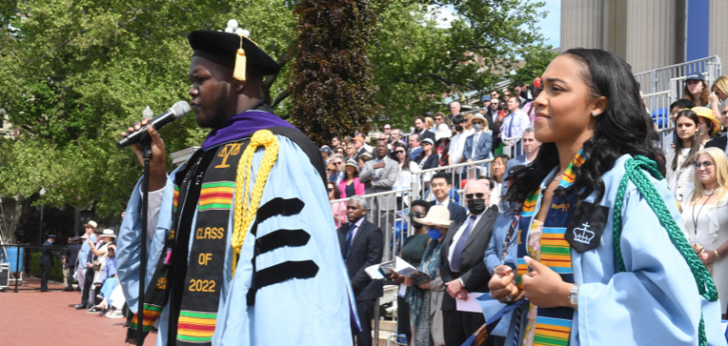 2022 graduating students singing and signing at university commencement