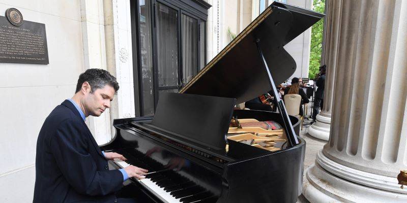 Tom Kitt performing on a grand piano for 2020 & 2021 university commencement