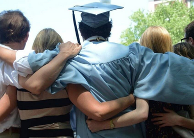 A Columbian graduate hand in hand with their family and friends