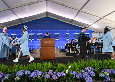 Students cross the SPS stage to receive their diplomas