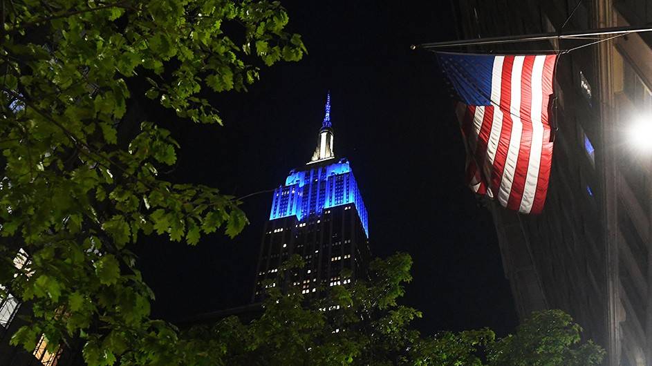 Empire State building lit up in Columbia blue