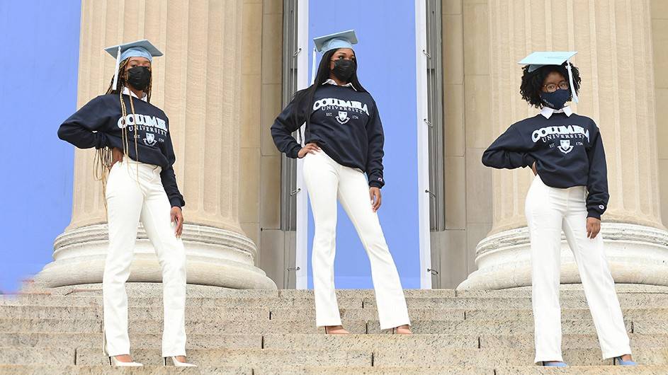 3 Columbia graduates posing in front of Low Library pillars